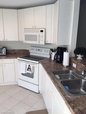 a kitchen with granite countertop a sink and a stove