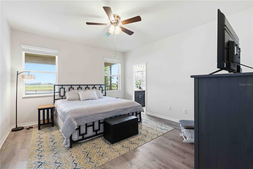 10920 79th Street East Parrish, FL 34219 - Photo 32 of 73 a bedroom with a bed and a chandelier