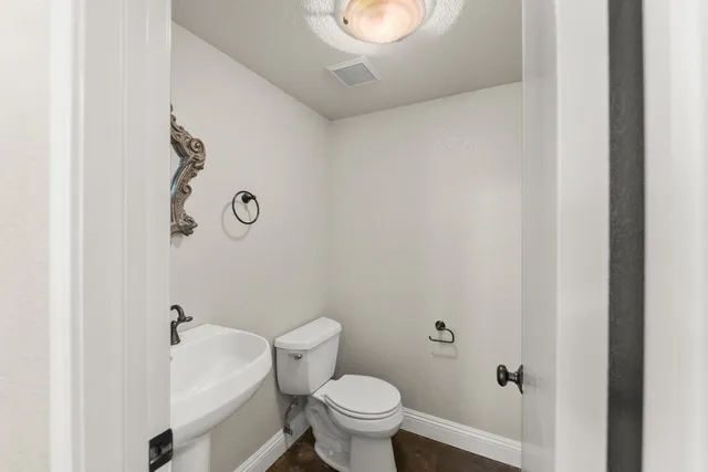 a white toilet sitting next to a white tub
