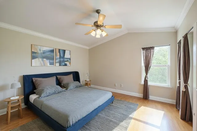 a bedroom with a large bed and a window