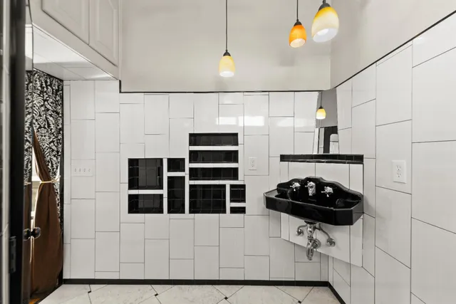 a kitchen with stainless steel appliances a stove a sink and a refrigerator