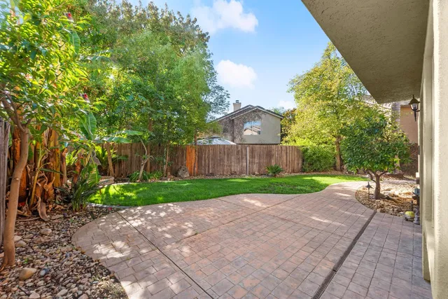 a view of backyard with a garden and trees