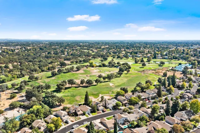 an aerial view of residential houses with outdoor space