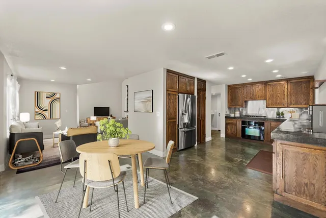 a dining room with furniture and a view of kitchen
