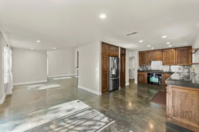 a view of a living room kitchen and a sink