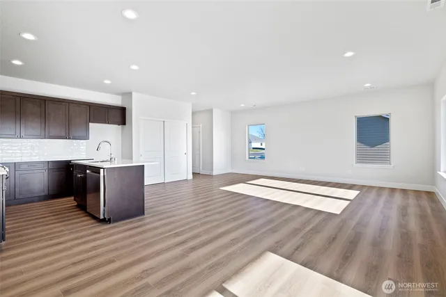 a large room with a lot of cabinets and wooden floor