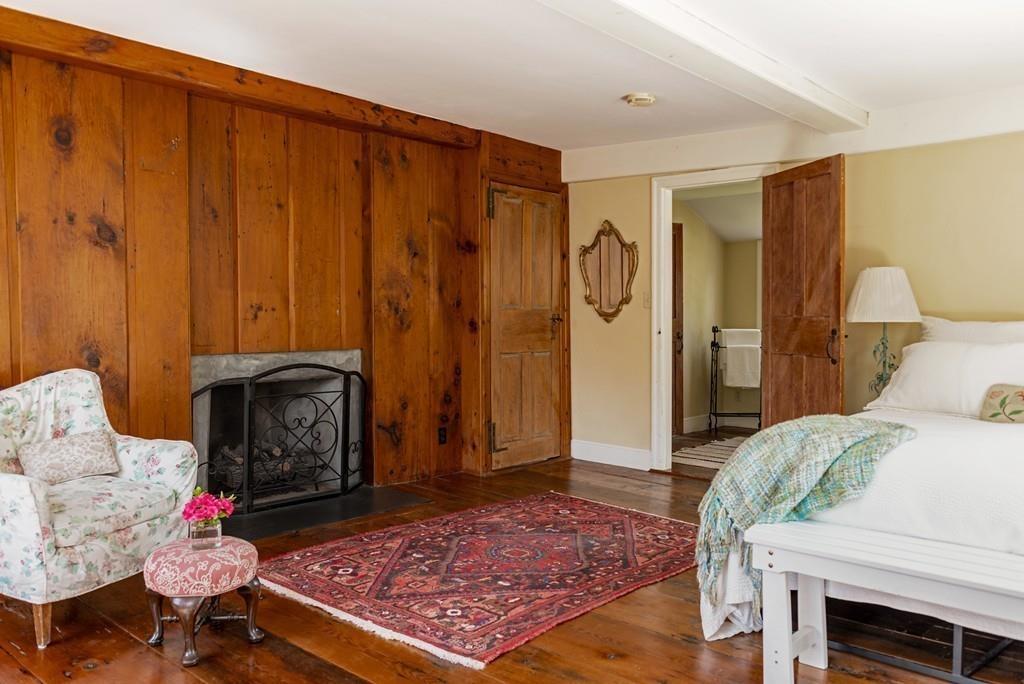 168 Argilla Road Ipswich, MA 01938 - Photo 16 of 32 a living room with furniture a rug and a fireplace
