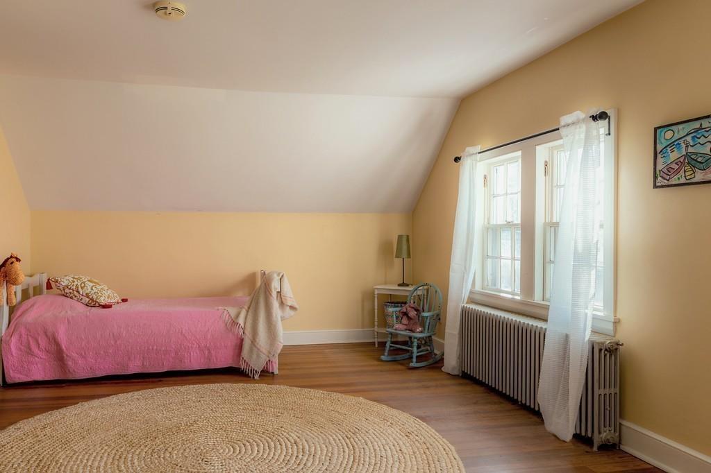 168 Argilla Road Ipswich, MA 01938 - Photo 23 of 32 a bedroom with a bed a table and dresser