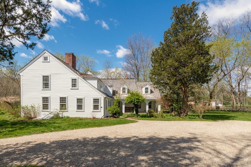 168 Argilla Road Ipswich, MA 01938 - Photo 4 of 32 a view of a white house with a yard and plants