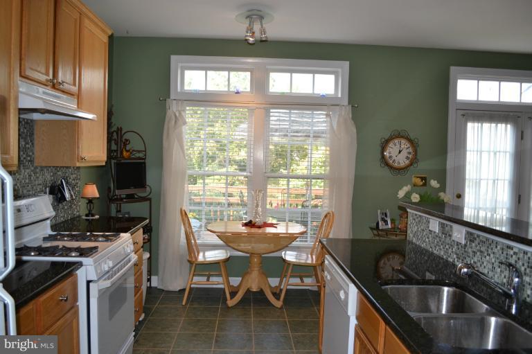 6650 Debra Lu Way Springfield, VA 22150 - Photo 20 of 25 a kitchen with granite countertop a sink stove and cabinets