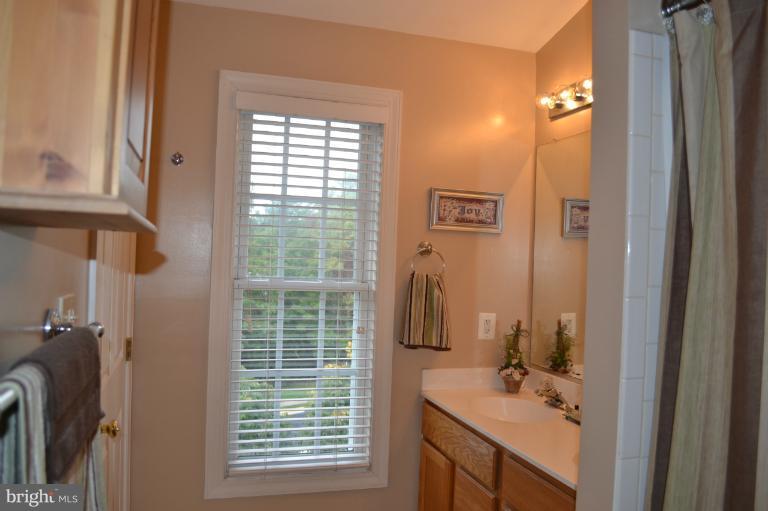 6650 Debra Lu Way Springfield, VA 22150 - Photo 4 of 25 a bathroom with a sink a mirror and a window