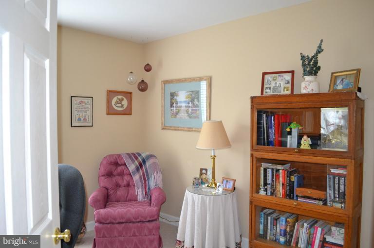 6650 Debra Lu Way Springfield, VA 22150 - Photo 7 of 25 a living room with furniture a book shelf and a book shelf