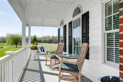 a view of a chairs and table in patio with a garden