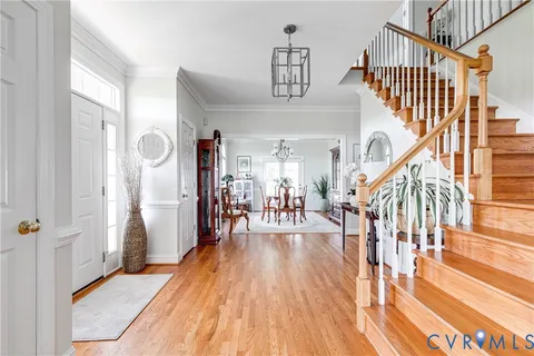 a view of entryway and hall with wooden floor