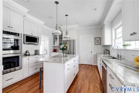a kitchen with a sink stove and refrigerator
