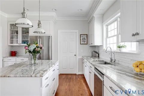 a kitchen with a sink stove and window