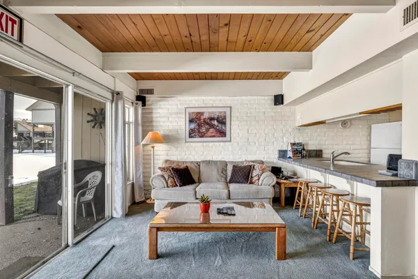 a view of a dining room with furniture large window and wooden floor