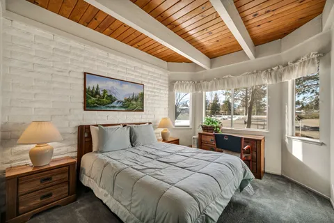 a bedroom with a bed and a chair