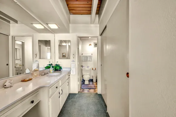 a spacious bathroom with a shower sink and mirror
