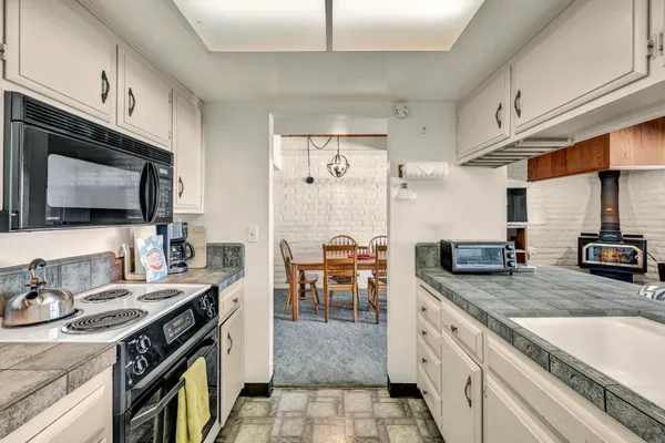 a kitchen with stainless steel appliances granite countertop a sink and cabinets