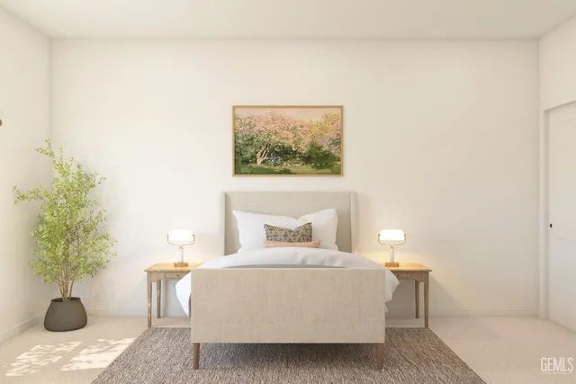 a bedroom with a bed and a potted plant