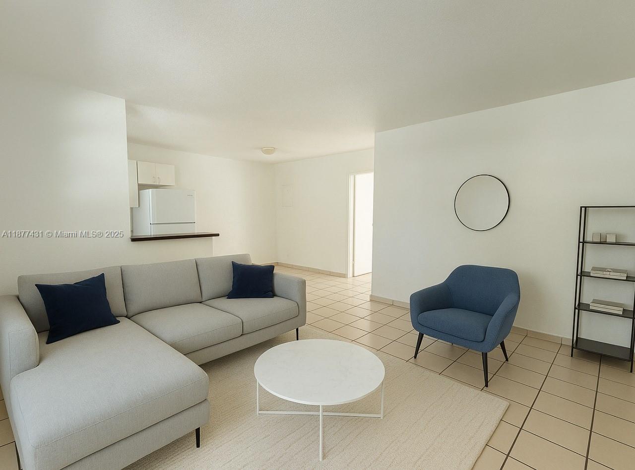 855 West 29th Street, Unit 19 Hialeah, FL 33012 - Photo 3 of 8 a living room with furniture a rug and a couch