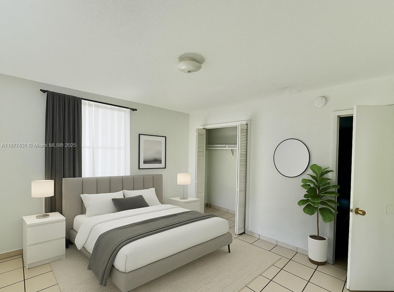 855 West 29th Street, Unit 19 Hialeah, FL 33012 - Photo 4 of 8 a bedroom with a bed and a window