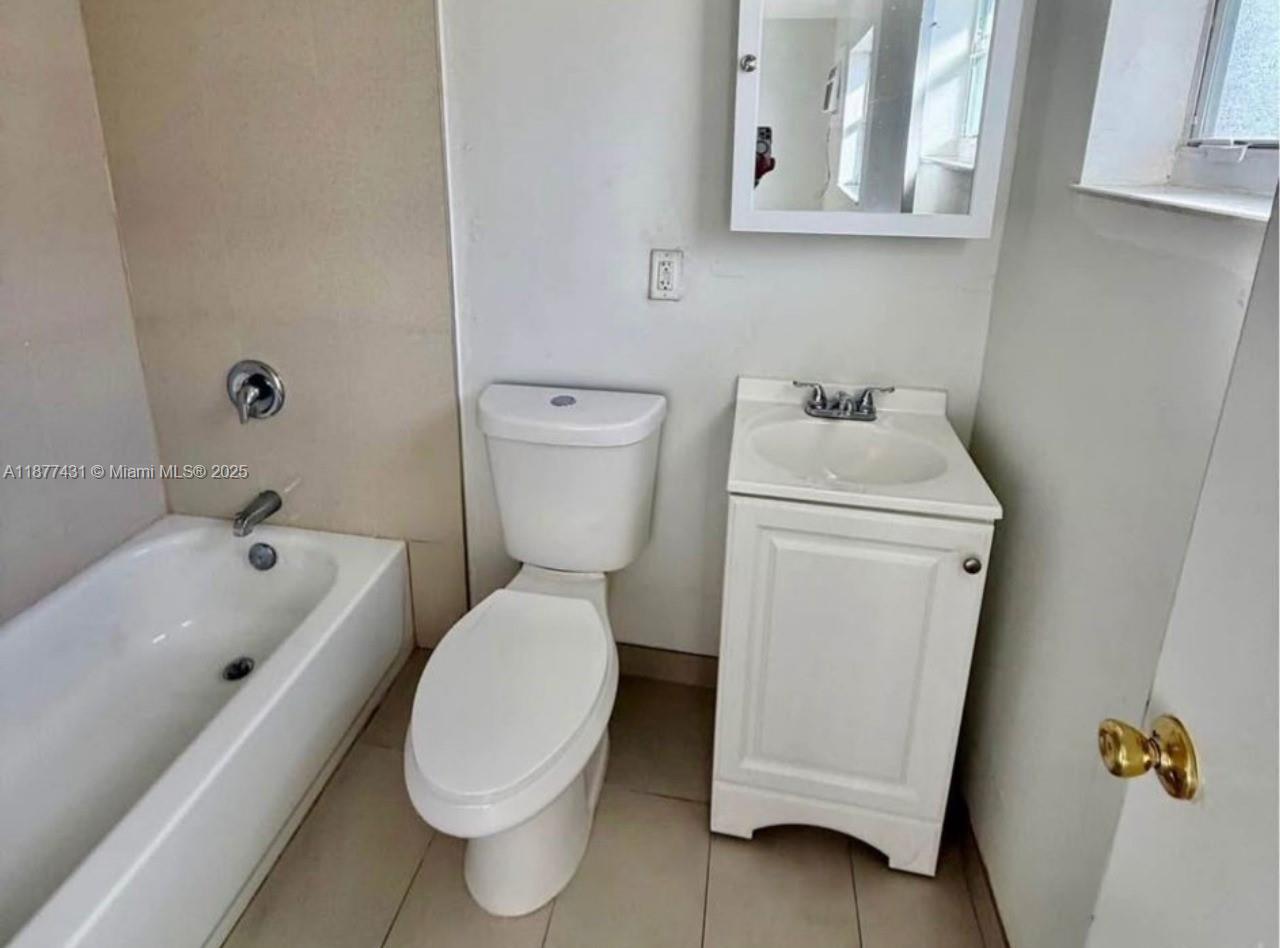 855 West 29th Street, Unit 19 Hialeah, FL 33012 - Photo 6 of 8 a white toilet sitting next to a bathroom sink