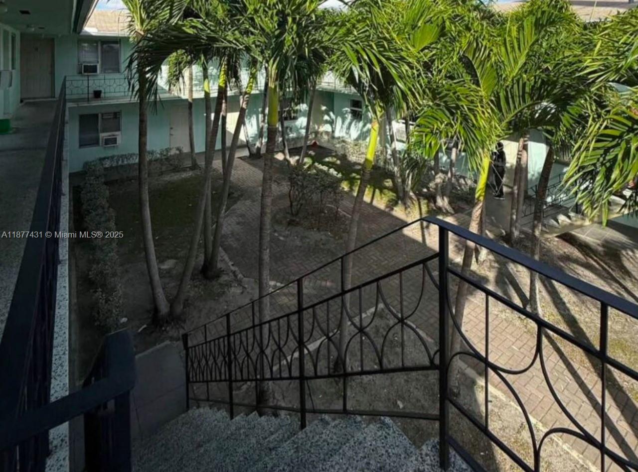 855 West 29th Street, Unit 19 Hialeah, FL 33012 - Photo 8 of 8 a backyard of a house with table and chairs