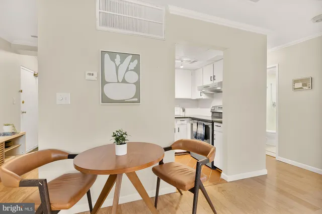 a view of a dining room with furniture and wooden floor