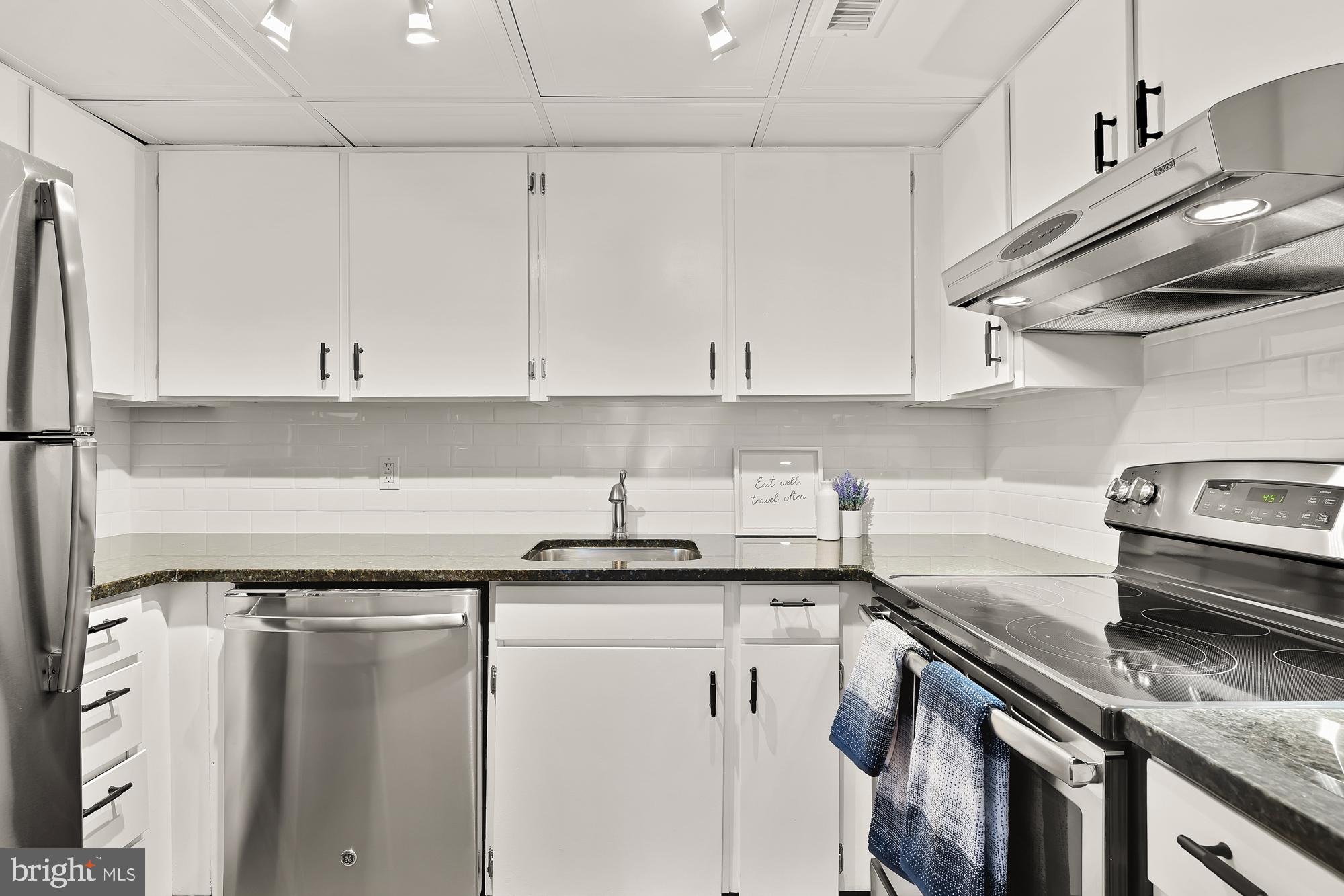 1801 Park Road Northwest, Unit 2 Washington, DC 20010 - Photo 13 of 45 a kitchen with stainless steel appliances granite countertop a sink stove and cabinets