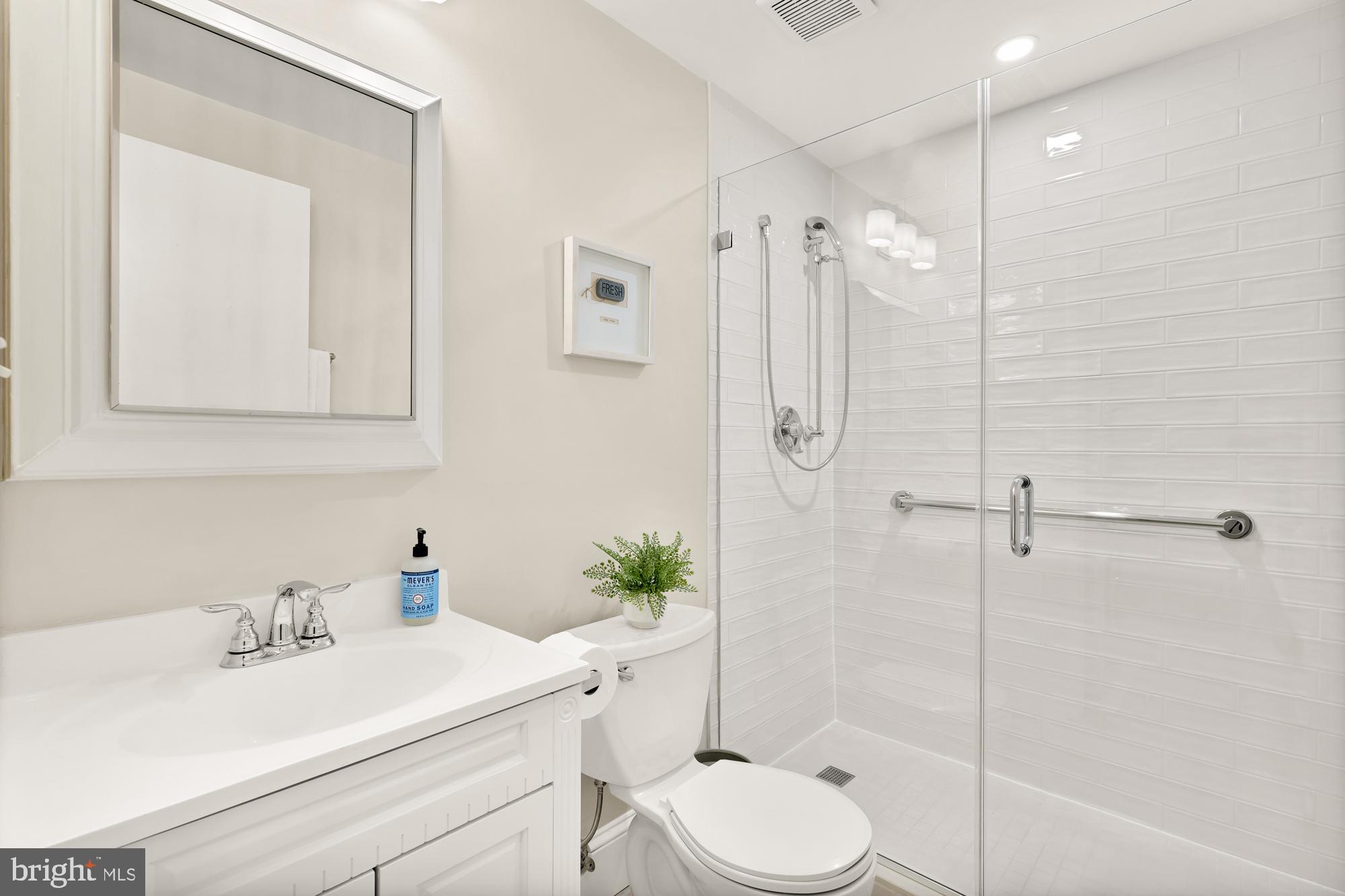 1801 Park Road Northwest, Unit 2 Washington, DC 20010 - Photo 20 of 45 a bathroom with a sink toilet a mirror and shower