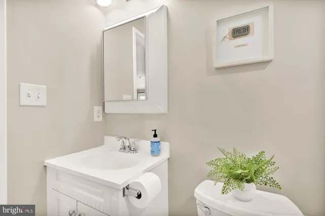 a bathroom with a sink mirror and vanity
