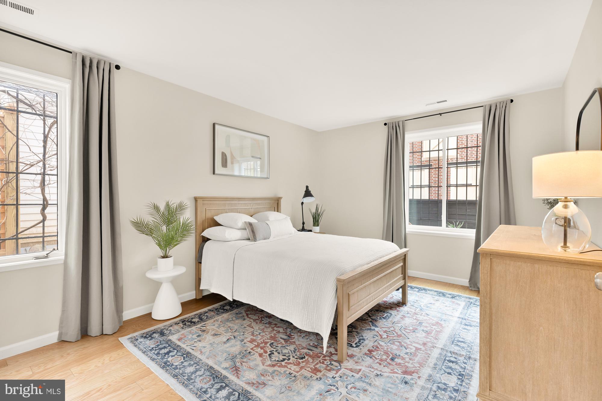 1801 Park Road Northwest, Unit 2 Washington, DC 20010 - Photo 23 of 45 a bedroom with a bed and wooden floor