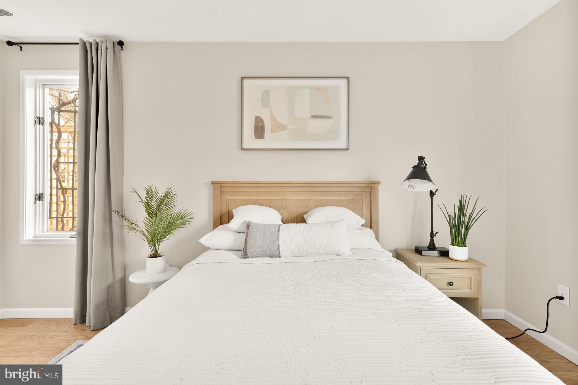1801 Park Road Northwest, Unit 2 Washington, DC 20010 - Photo 25 of 45 a bedroom with a large bed and a potted plant