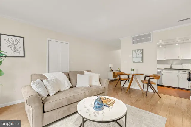 a living room with furniture kitchen view and a dining table