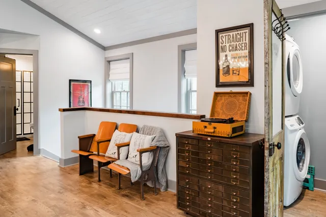 a room with furniture and paintings on the wall