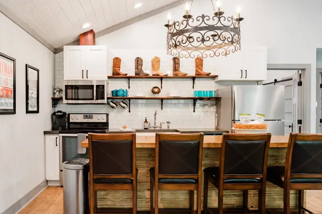 a dining table chair with kitchen island and a wooden floor