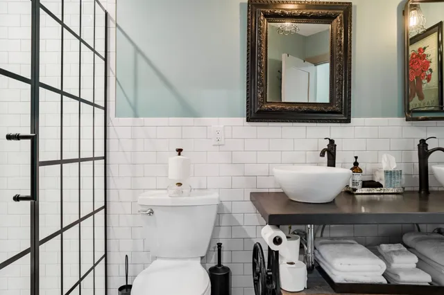 a bathroom with a toilet a sink and mirror