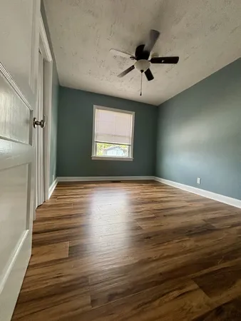a view of room window and wooden floor
