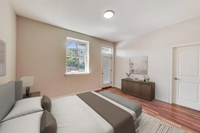 a bedroom with a bed and wooden floor