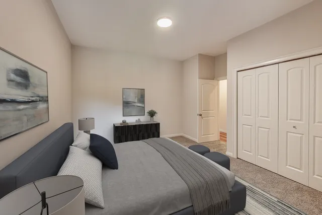 a bedroom with a bed and a couch