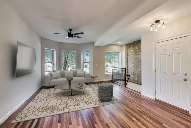 a living room with furniture and wooden floor