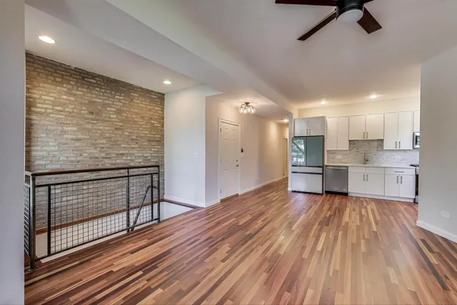 a view of kitchen with wooden floor and electronic appliances