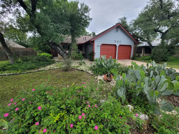 a view of a house with a backyard and garden