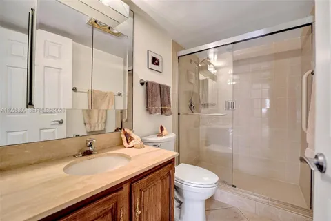 a bathroom with a sink and mirror with toilet