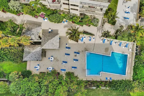 a view of a tall building with a yard