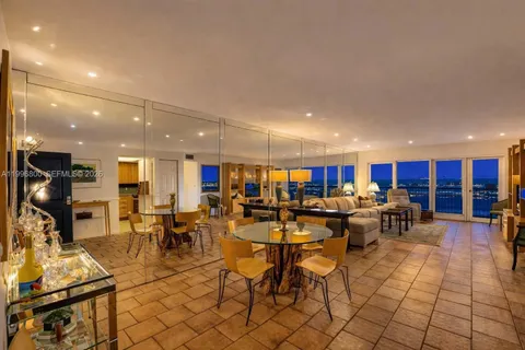 a living room with lots of furniture and kitchen view