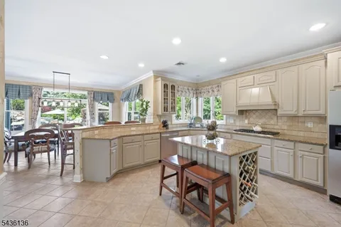 a kitchen with sink a table and chairs in it