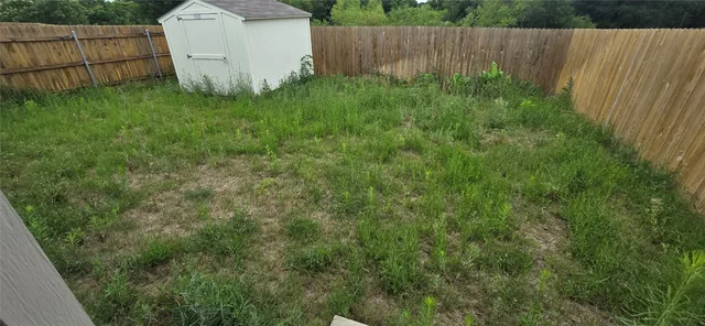 a view of an empty room and a window
